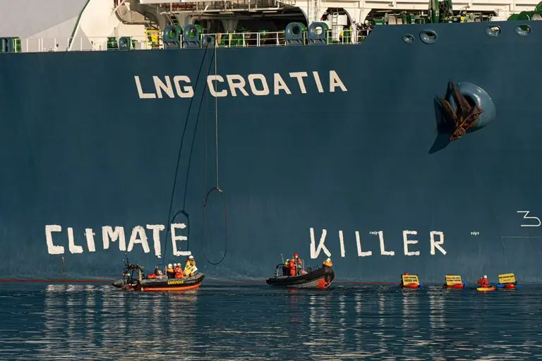 Greenpeace activists write a message on Croatian FSRU